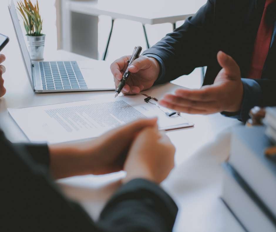 Business professionals reviewing documents, indicative of Fluid IT's personalized consulting services that collaborate with your team to enhance IT operations.