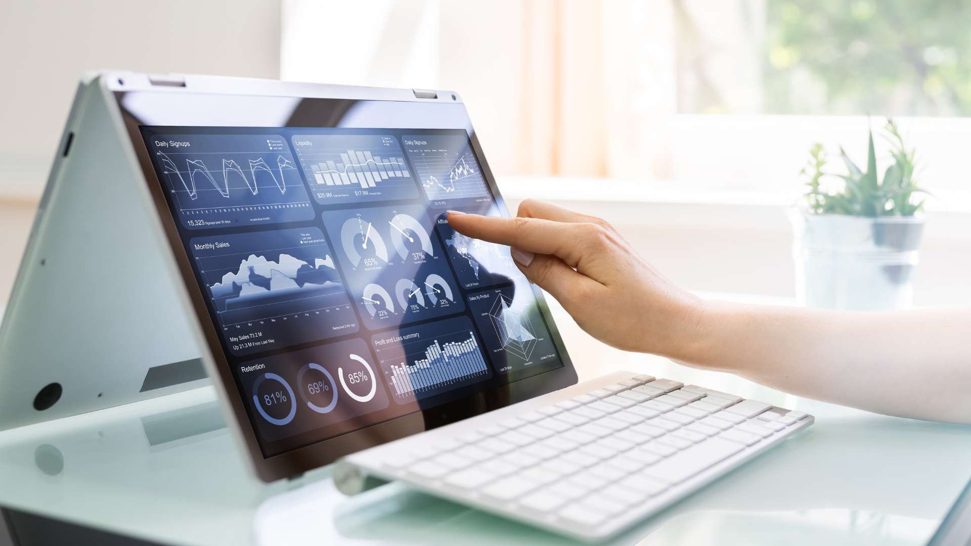 Person using a touchscreen to navigate cutting-edge business analytics, highlighting Fluid IT's focus on equipping companies with the latest technology solutions.
