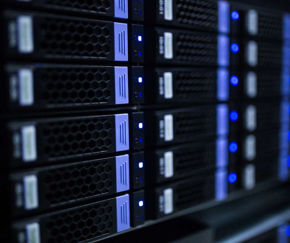 Close-up view of a data center server rack with glowing blue lights, representing the comprehensive IT support services provided by Fluid IT to ensure seamless operations.