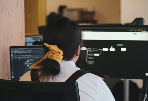 A girl working on windows using Cloud technology.