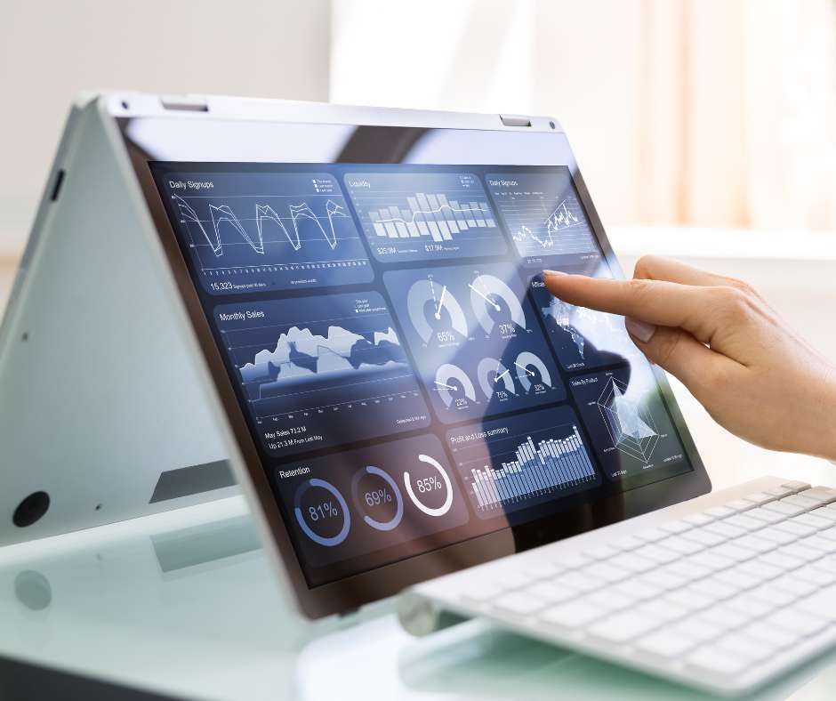 Close-up of a hand interacting with an analytics dashboard on a convertible laptop, symbolizing Fluid IT's preemptive issue resolution through advanced monitoring for Frisco businesses.